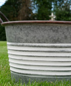 Metal basin on grass with blurred background