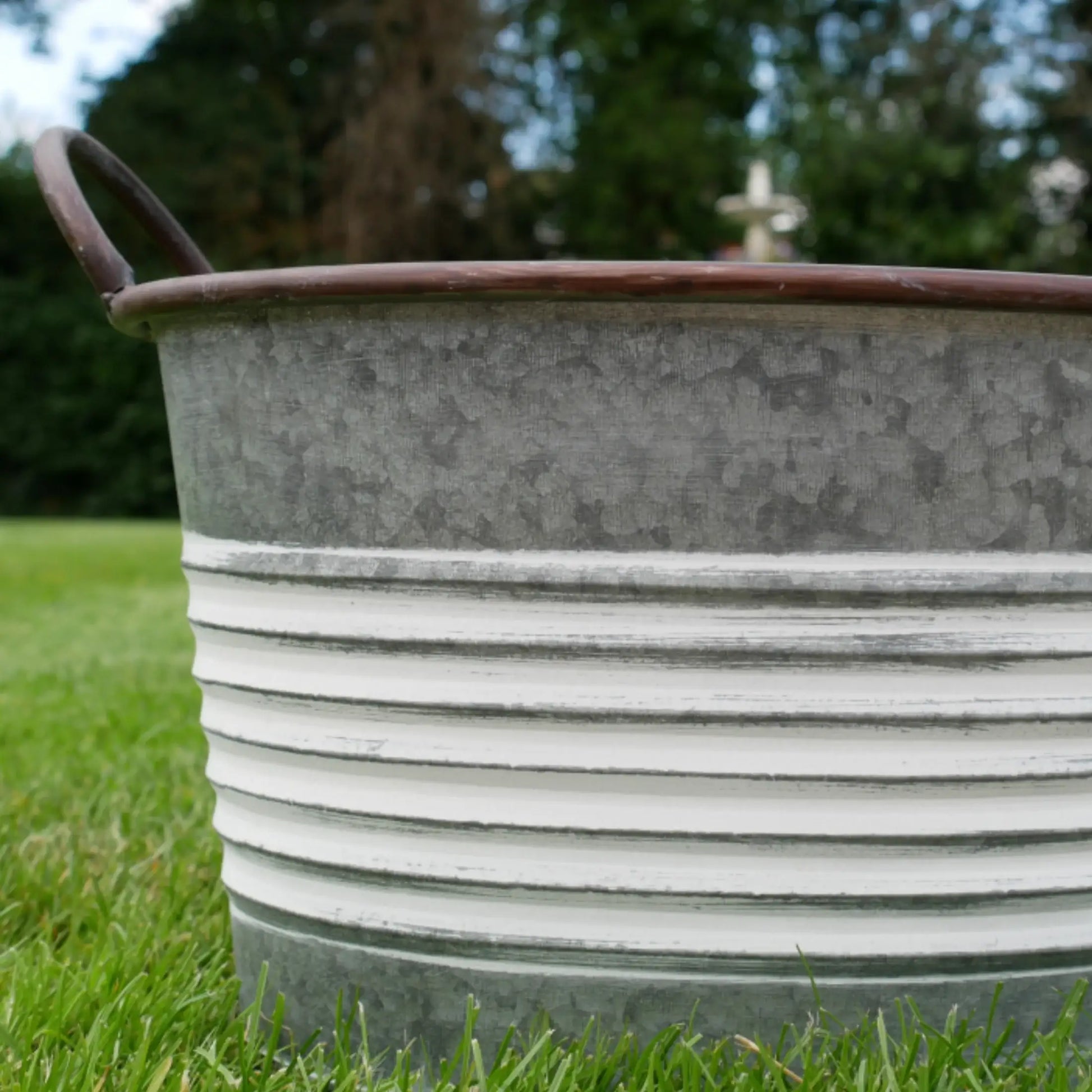 Metal basin on grass with blurred background