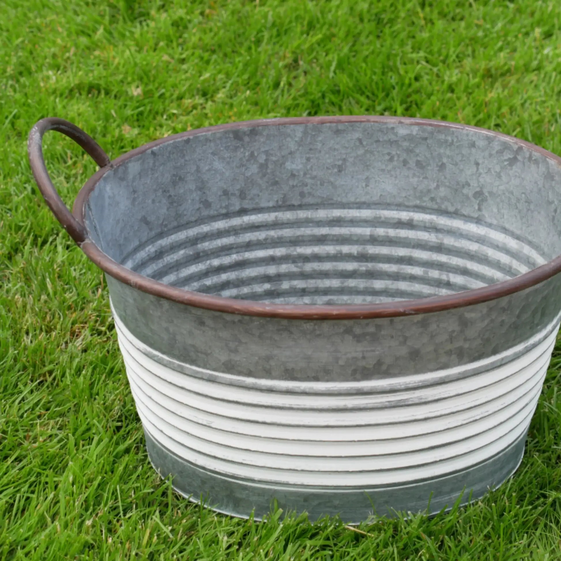 Metal bucket on grass