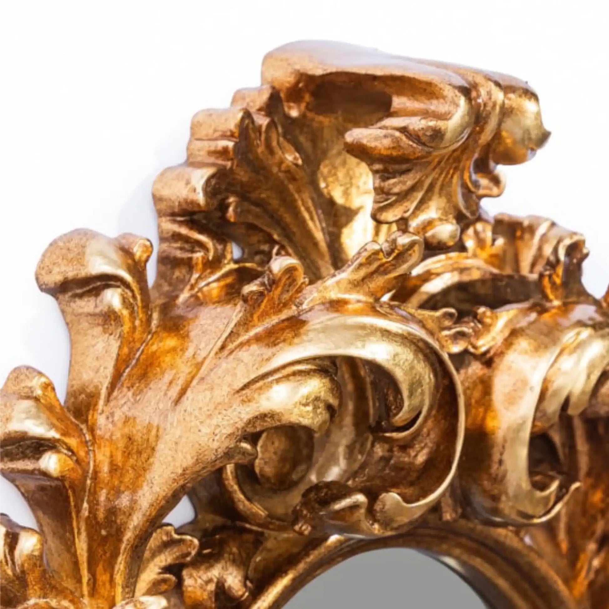 Close-up of an ornate gold decorative piece with intricate leaf and scroll designs.