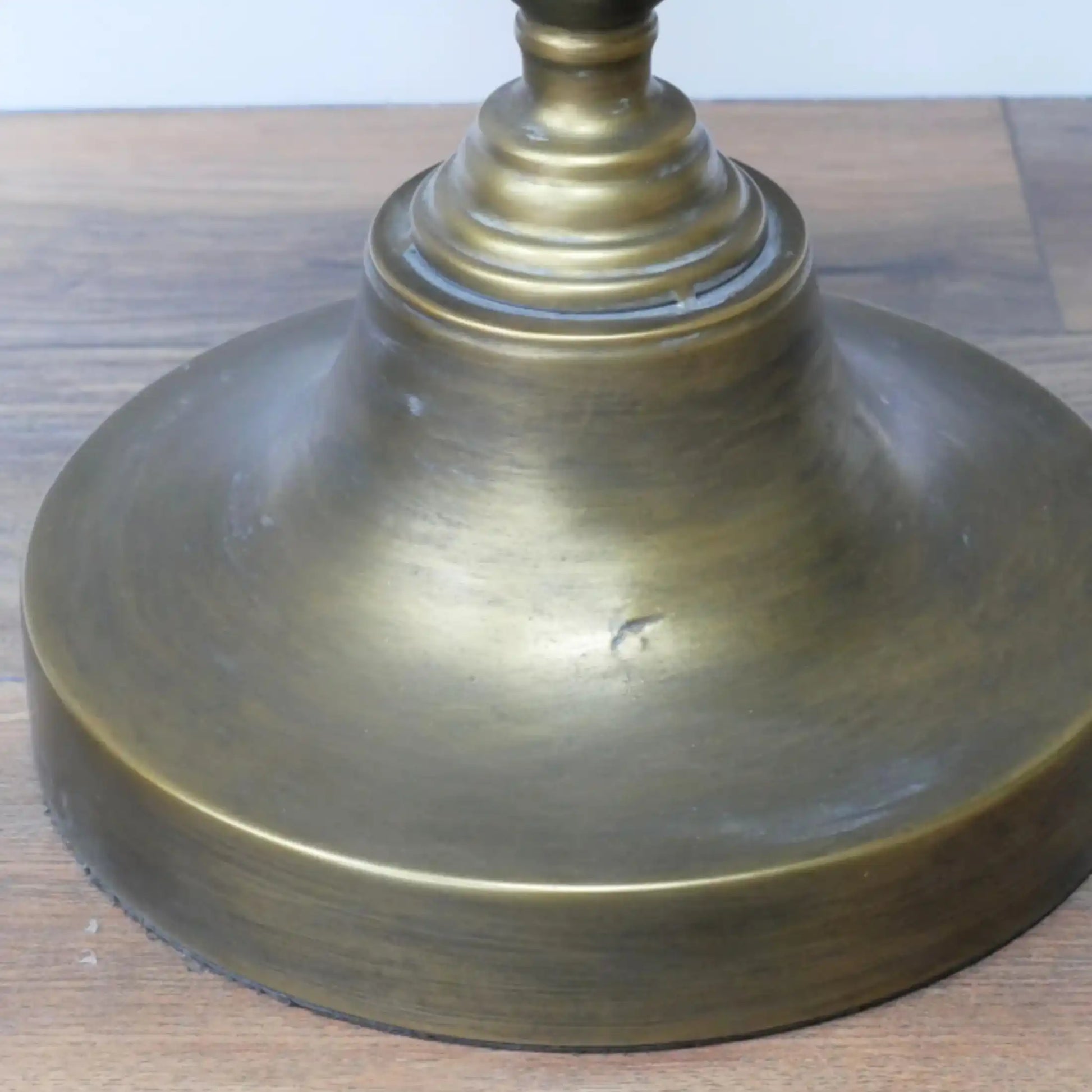 Brass lampshade on a wooden surface