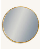 Round mirror with a gold frame on a white background
