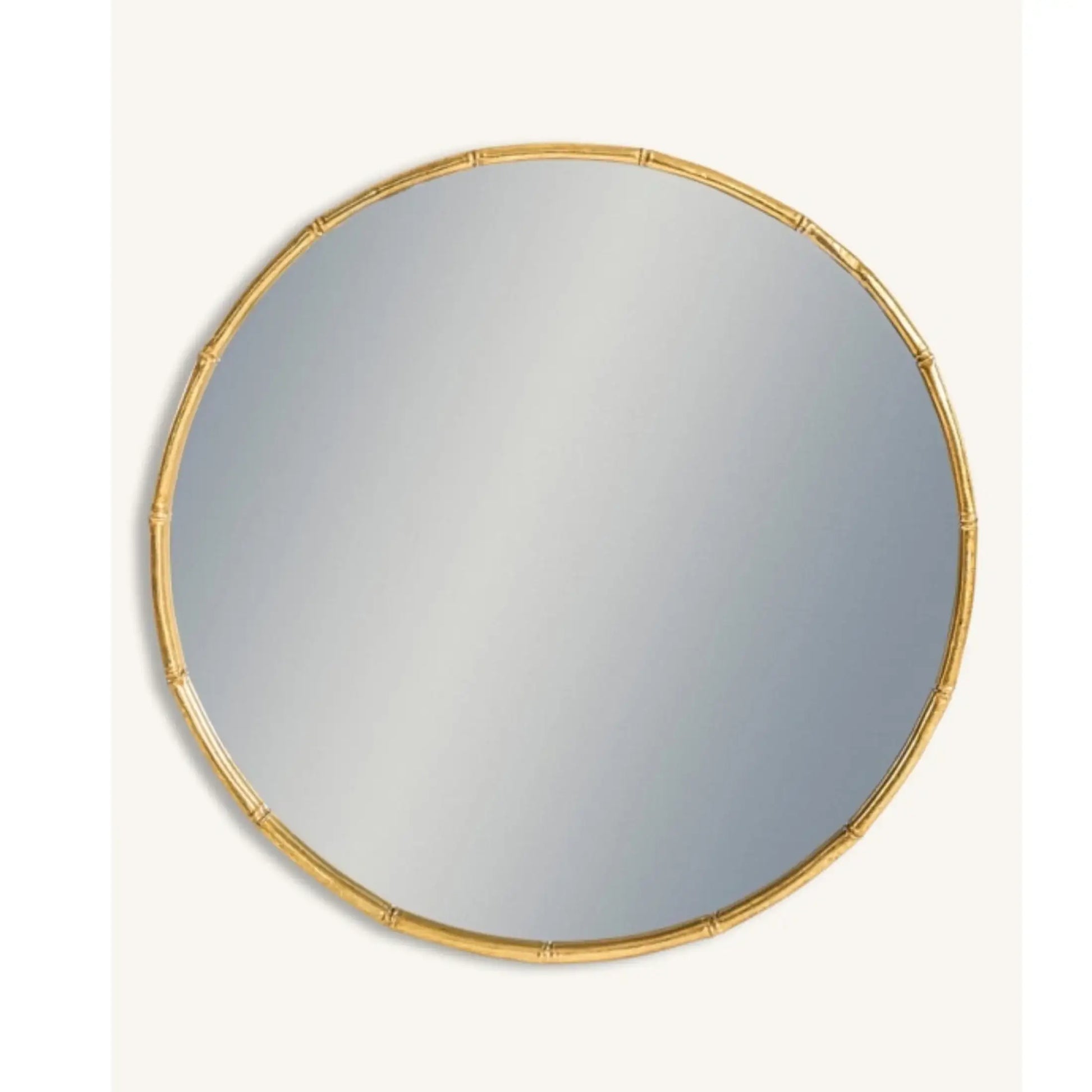 Round mirror with a gold frame on a white background