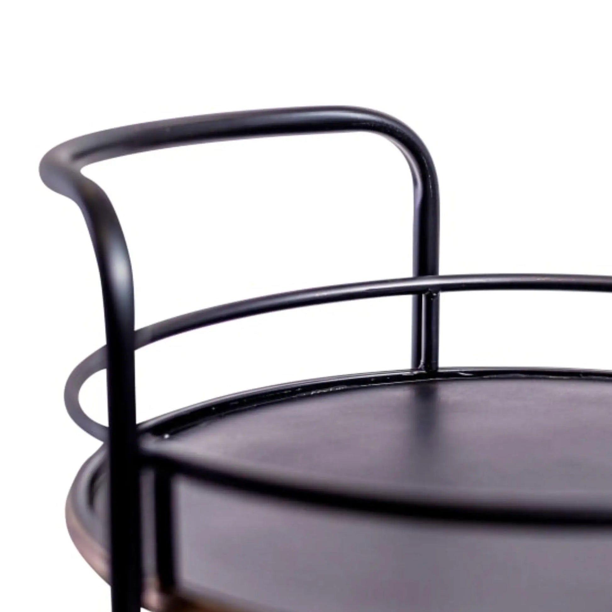 Close-up of a black metal chair with a white background