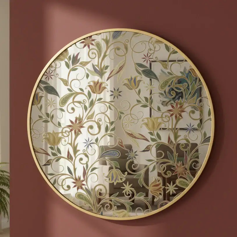 Decorative round mirror with floral patterns on a red wall