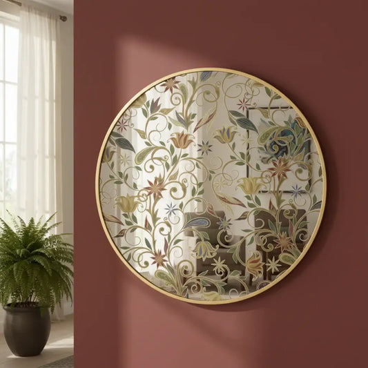Decorative round mirror with floral pattern on a red wall