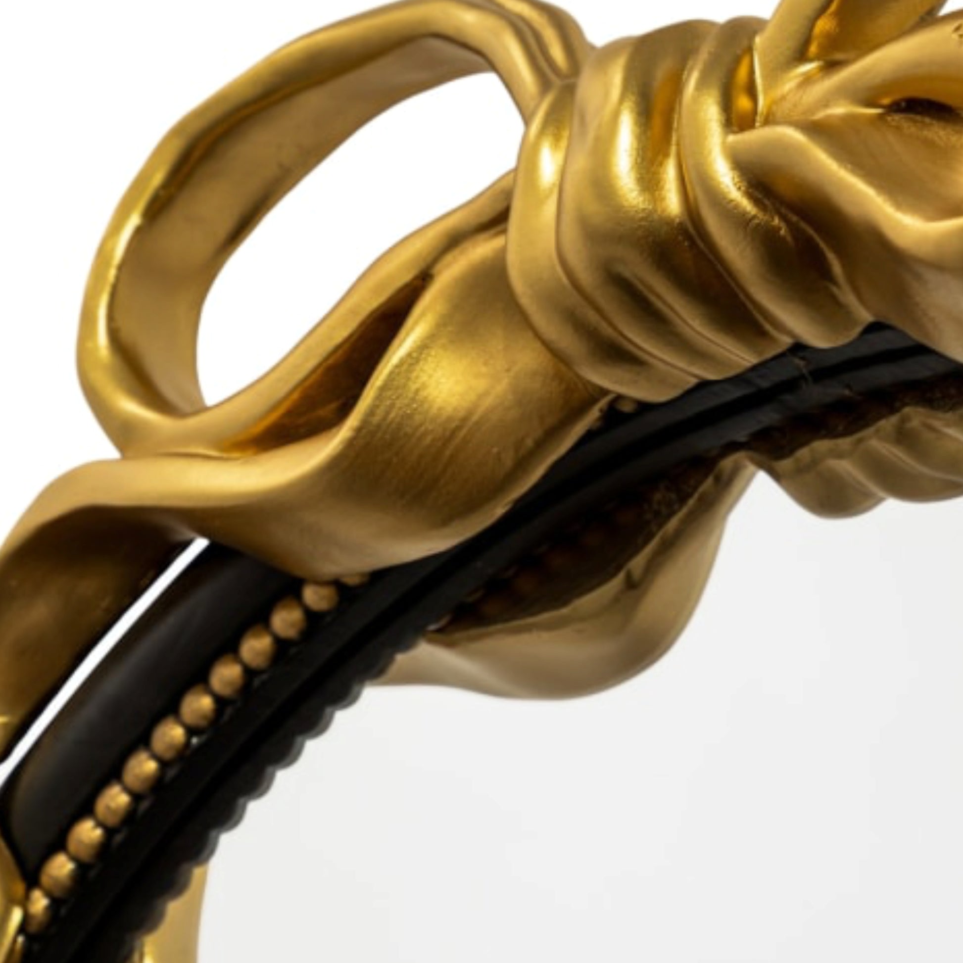 Close-up of a gold and black decorative item with intricate design