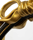 Close-up of a gold and black decorative item with intricate design