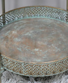 Decorative metal tray with intricate patterns on a textured surface