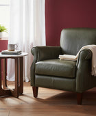 Small round table with marble top and wooden legs on a wooden floor.