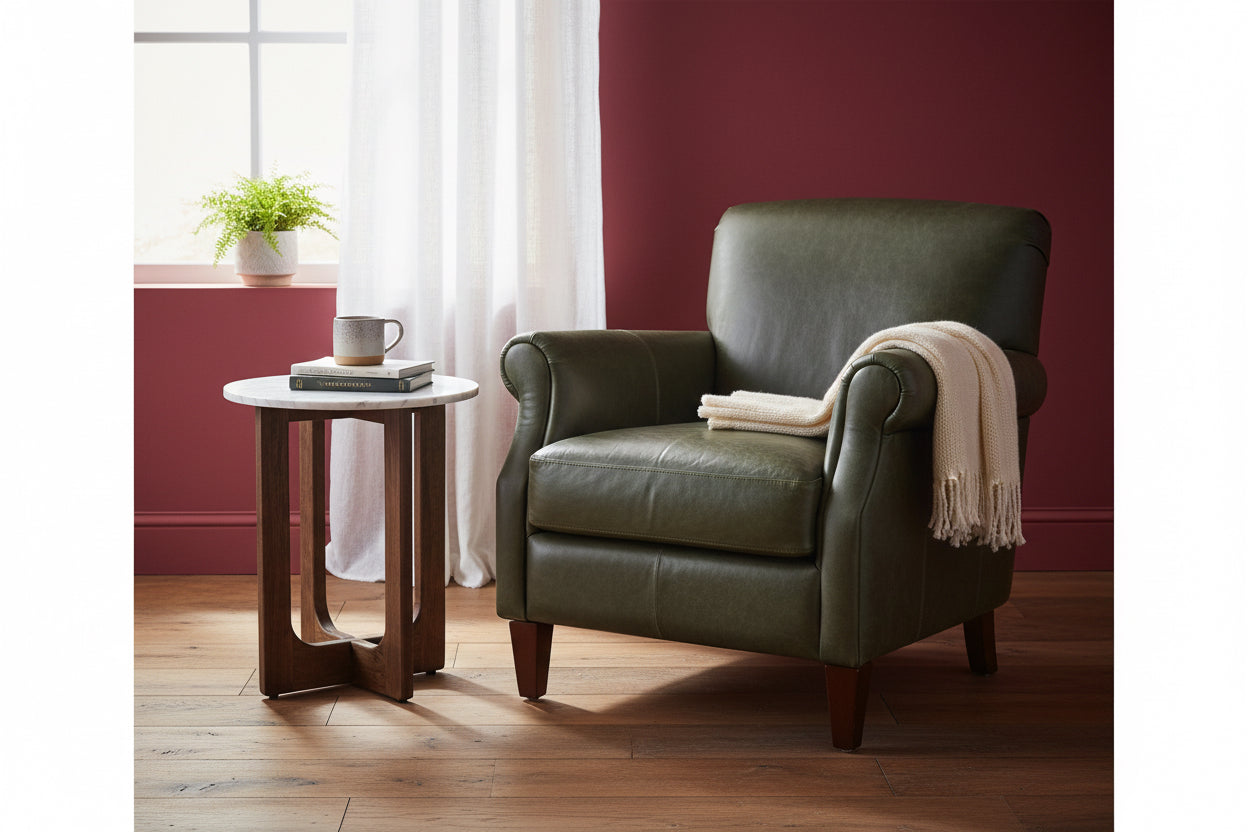Small round table with marble top and wooden legs on a wooden floor.