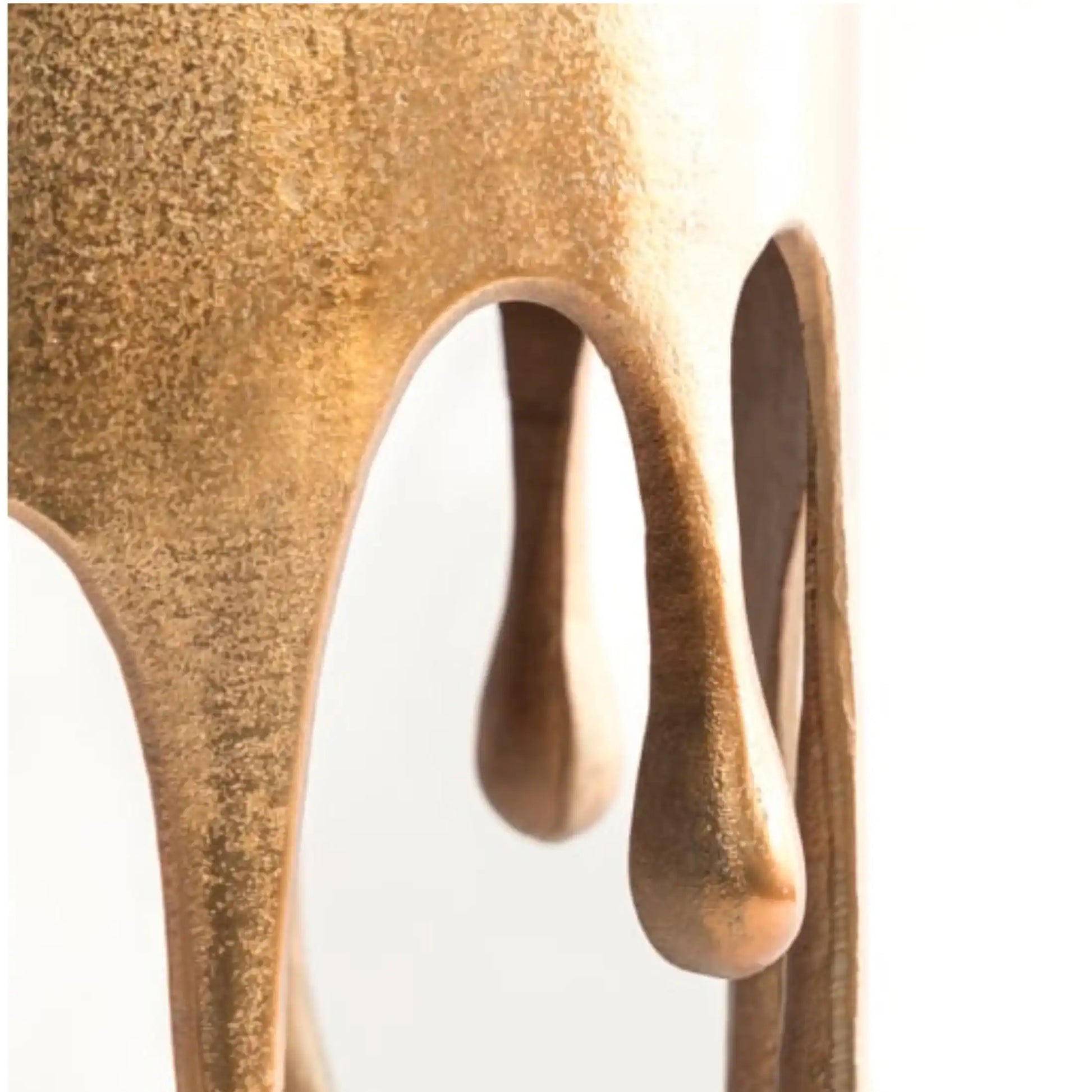 Close-up of a textured bronze sculpture on a white background