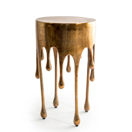 Bronze-colored side table with a unique design on a white background