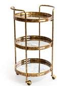 Gold three-tiered serving cart with glass shelves on a white background