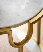 Round marble table with gold metal frame on a blurred background