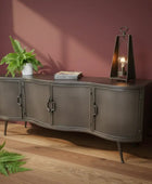Dark wood sideboard with decorative items against a gray wall