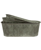 Set of three oval metal planters with a textured pattern on a white background