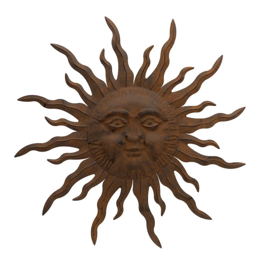 Decorative sun wall art with a face on a white background