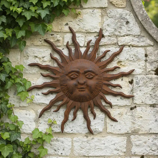Decorative sun wall art on a stone wall with ivy