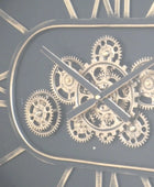Close-up of a clock with visible gears and Roman numerals on a dark background