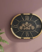 Decorative wall clock with gear design on a pink wall