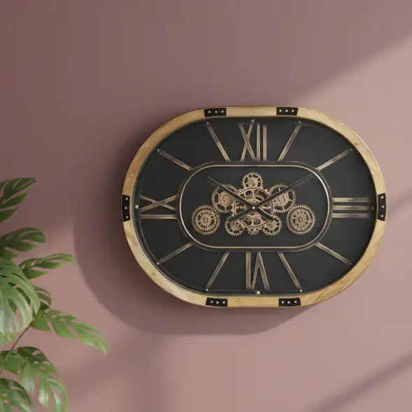 Decorative wall clock with gear design on a pink wall