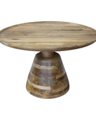 Wooden table with a round top and tiered base on a wooden floor.