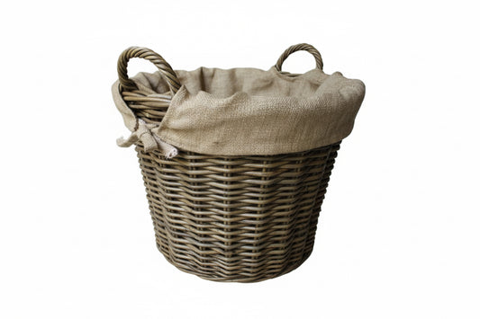 Wicker laundry basket with a hessian liner on a white background