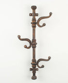 Decorative wall-mounted coat rack with multiple hooks on a white background