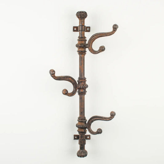Decorative wall-mounted coat rack with multiple hooks on a white background