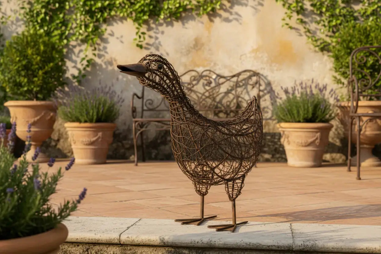 Decorative wire bird sculpture on a patio with potted plants and a bench.