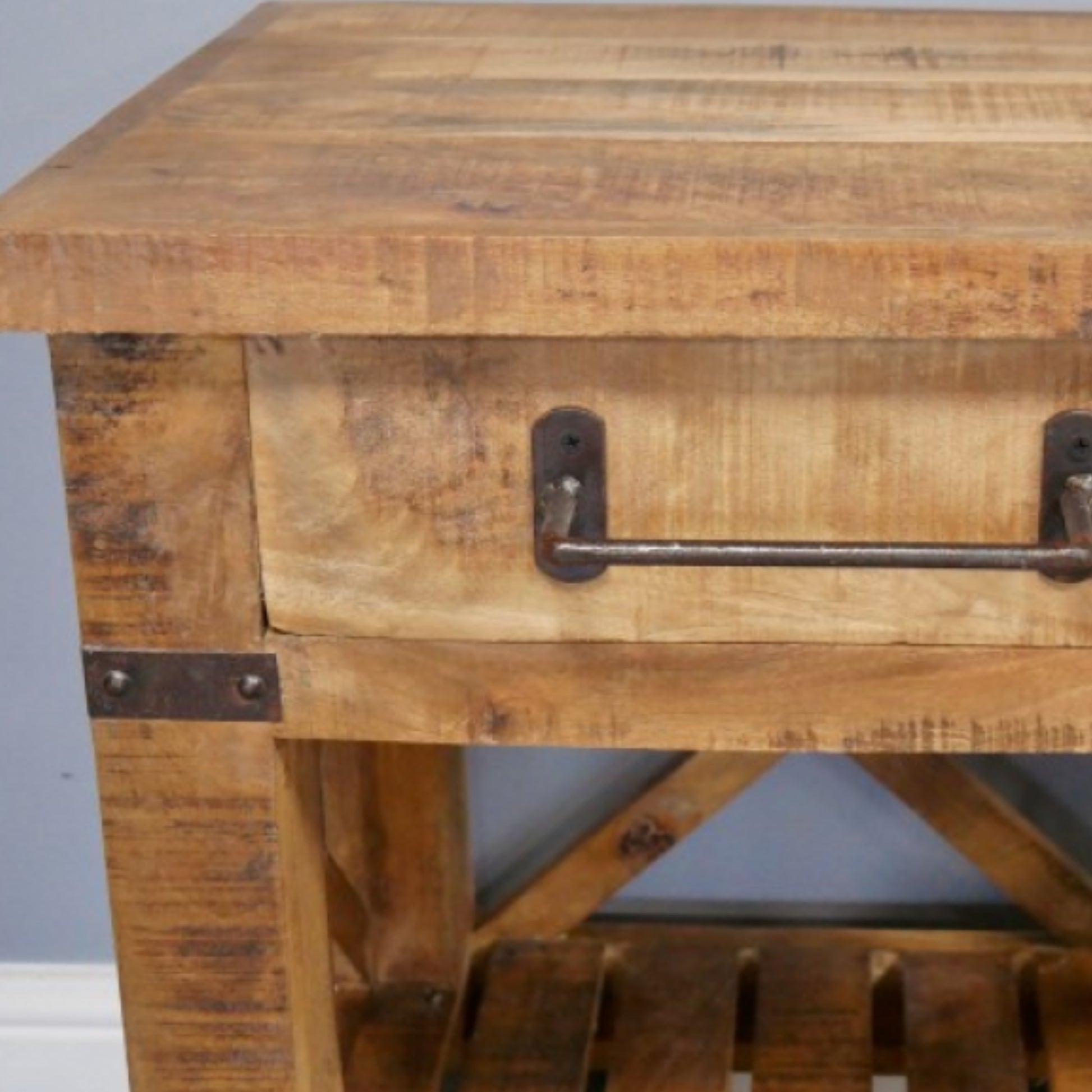 Wooden side table with a drawer and metal handle on a gray background