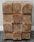 Wooden cube puzzle on a gray carpet with a white wall background