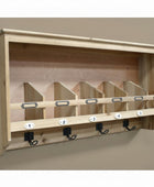 Wooden wall-mounted rack with hooks on a stone wall