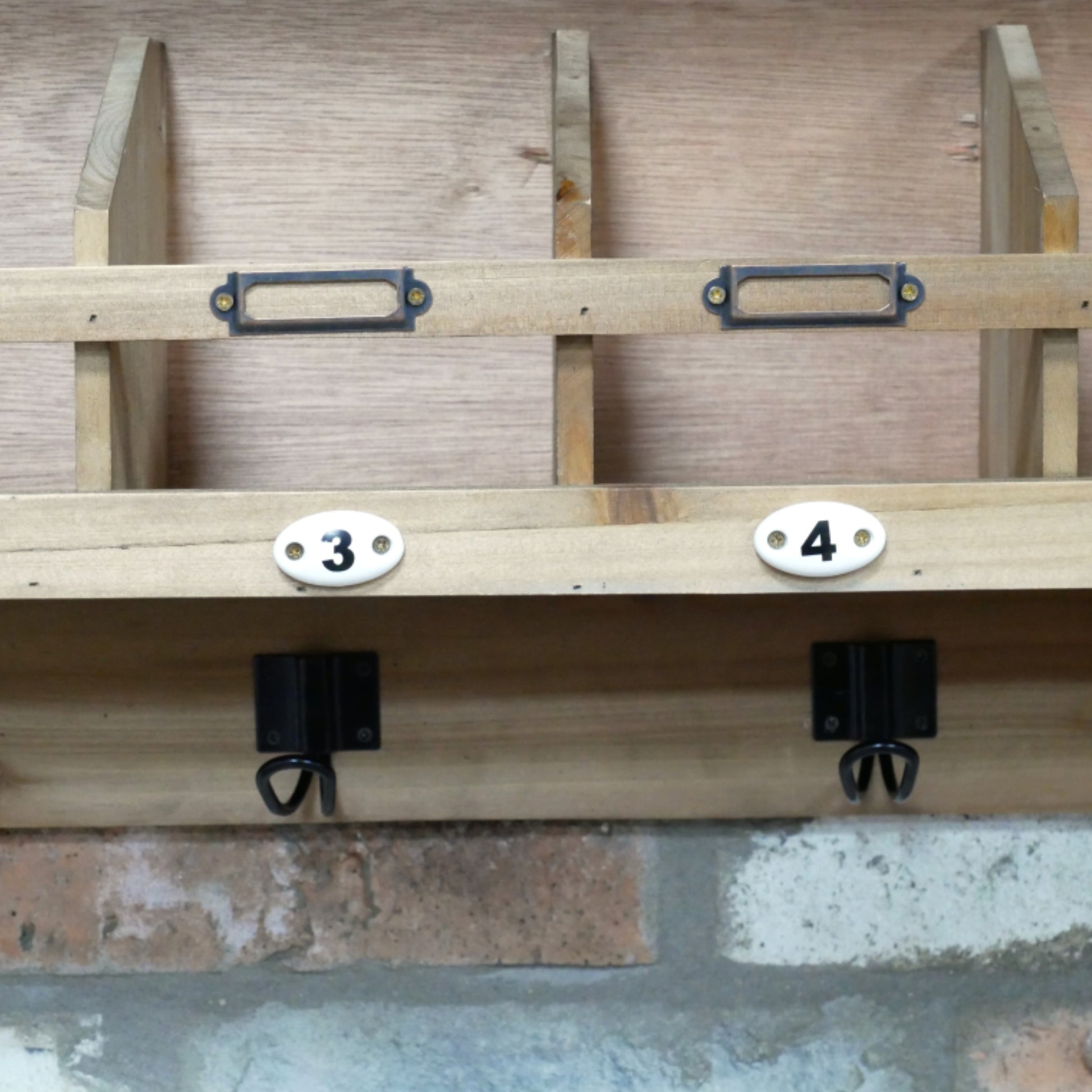 Wooden shelf with brackets and numbers on a concrete floor