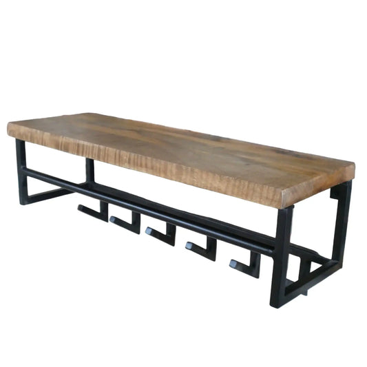 Wooden bench with black metal frame against a brick wall