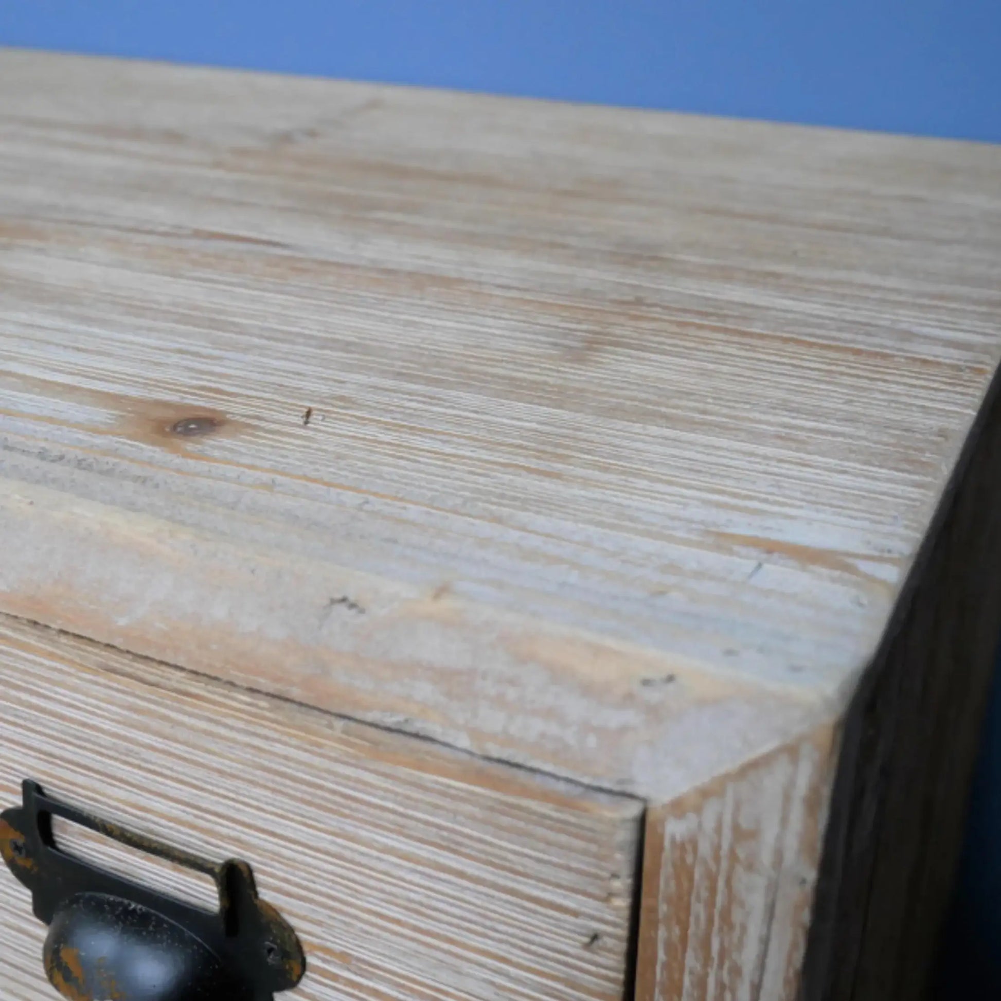 Wooden box with a metal handle on a blue background