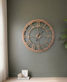 Wooden wall clock on a green wall with decor elements
