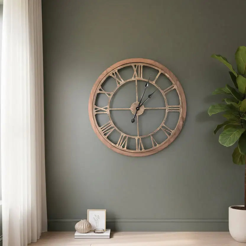 Wooden wall clock on a green wall with decor elements