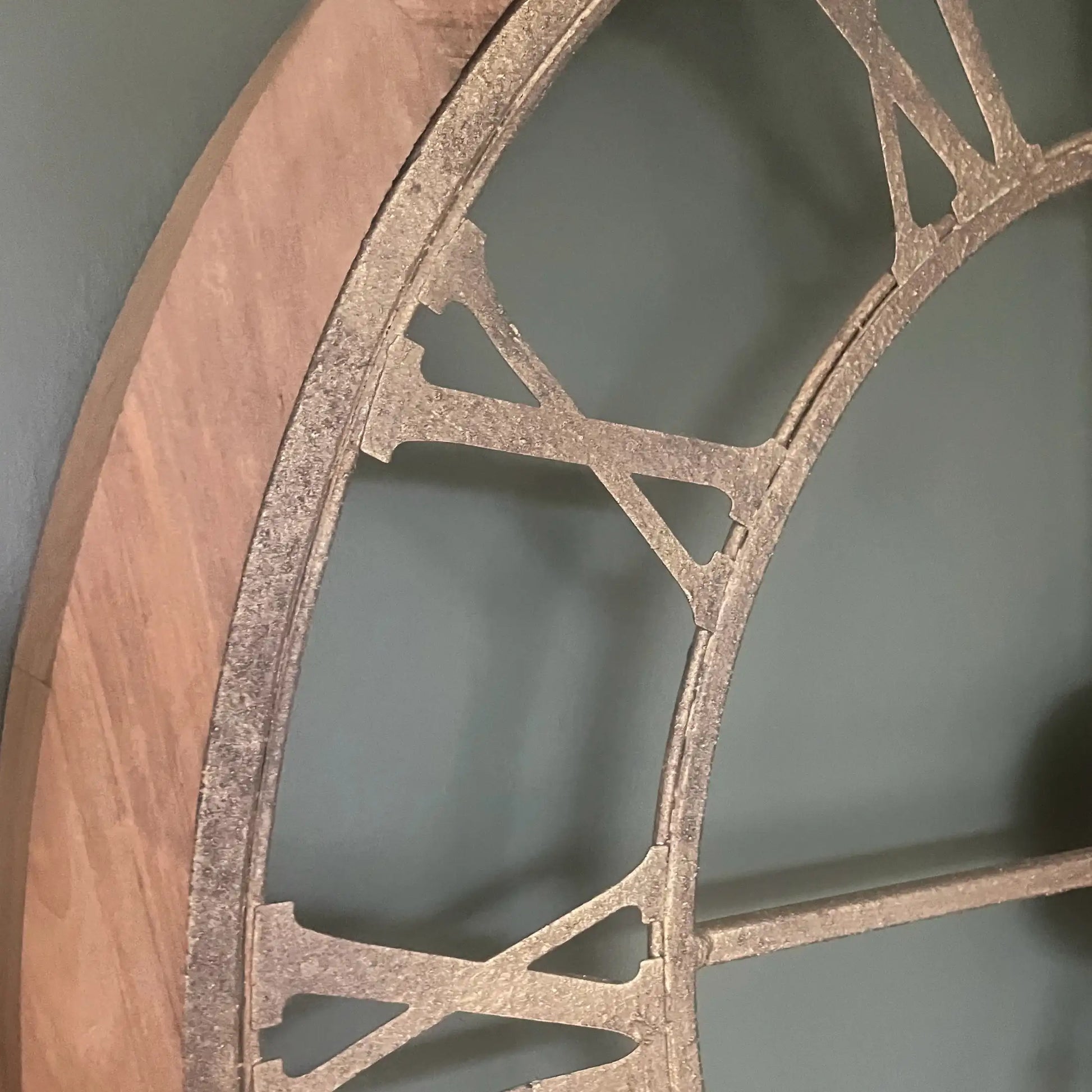 Decorative wall shelf with wooden edge and metal lattice design against a gray background