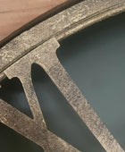 Close-up of a concrete block with water and wood in the background