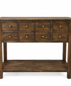 A rustic dark brown wooden console table with nine drawers, brass knobs, and an open lower shelf, shown against a plain white background.