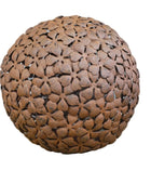 Decorative spherical object with a floral pattern on a wooden surface