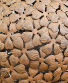Close-up of a decorative metal mesh with floral patterns
