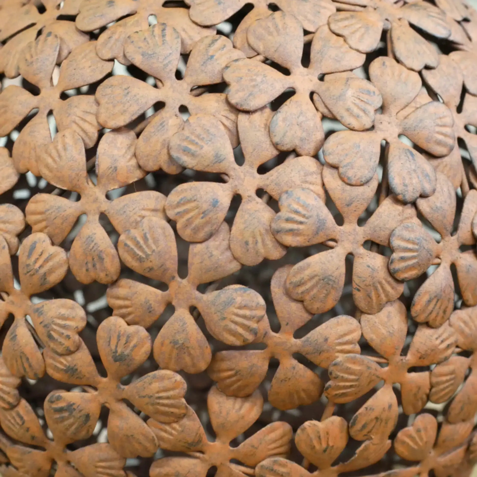 Close-up of a decorative metal mesh with floral patterns