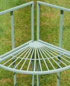 Light blue metal corner chair on a grassy background