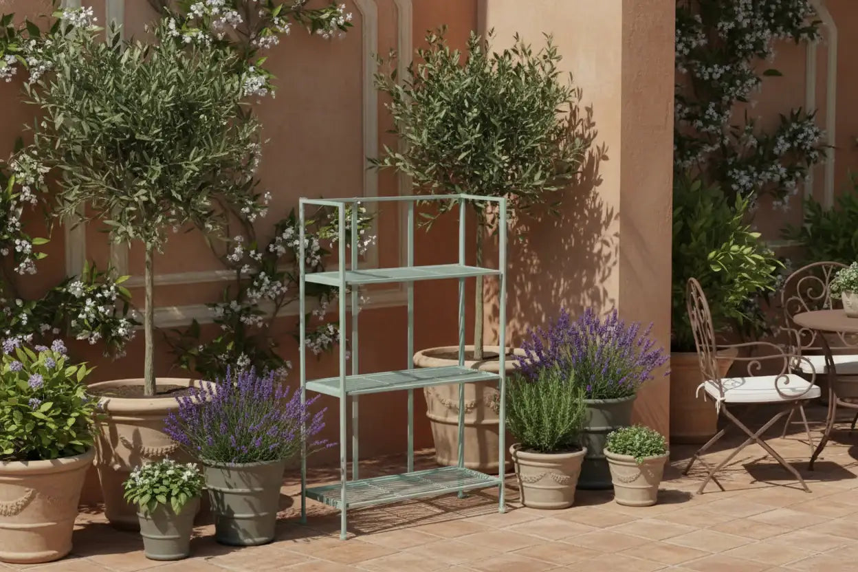 Decorative outdoor setting with potted plants and a metal shelf against a wall.