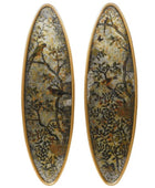 Oval-shaped earrings with nature-themed design on a white background