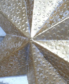Decorative metal star with intricate cut-out patterns on a textured surface
