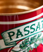 Close-up of a red can with 'PASSATA' branding and green text.